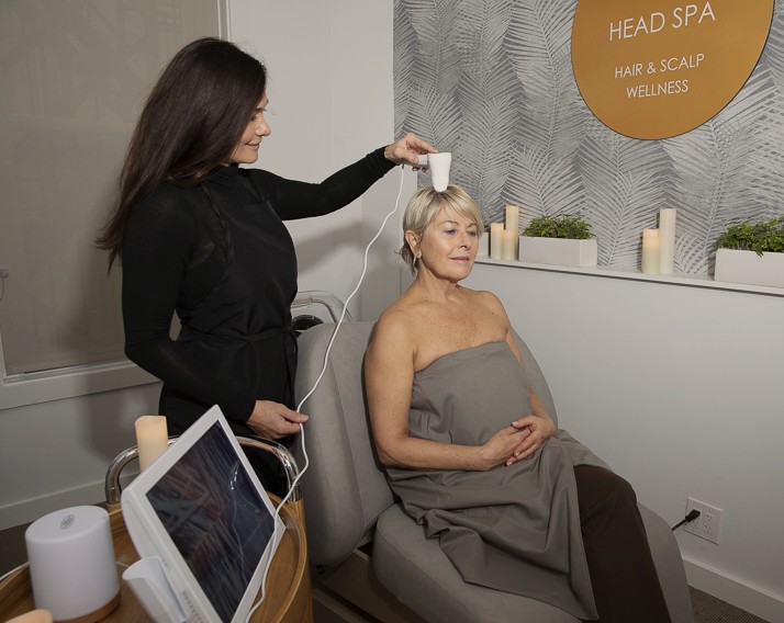Head Spa technician providing a hair and scalp analysis consultation to identify any scalp conditions that may need to be addressed